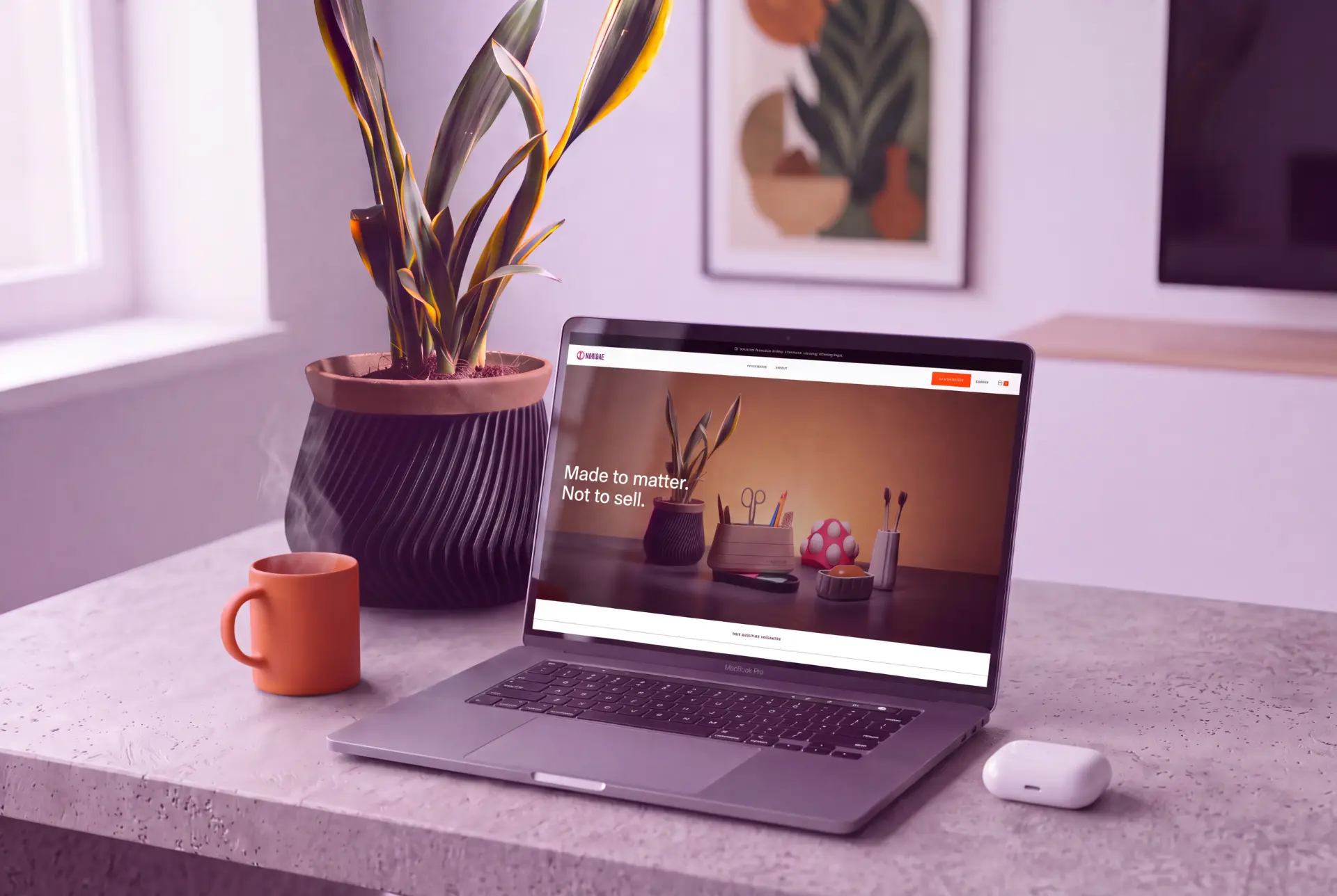 Dindie storefront on a laptop beside a 3D-printed planter on a desk